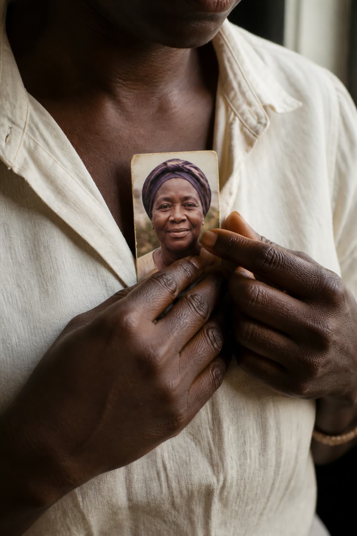 Hands holding a portrait close to the heart